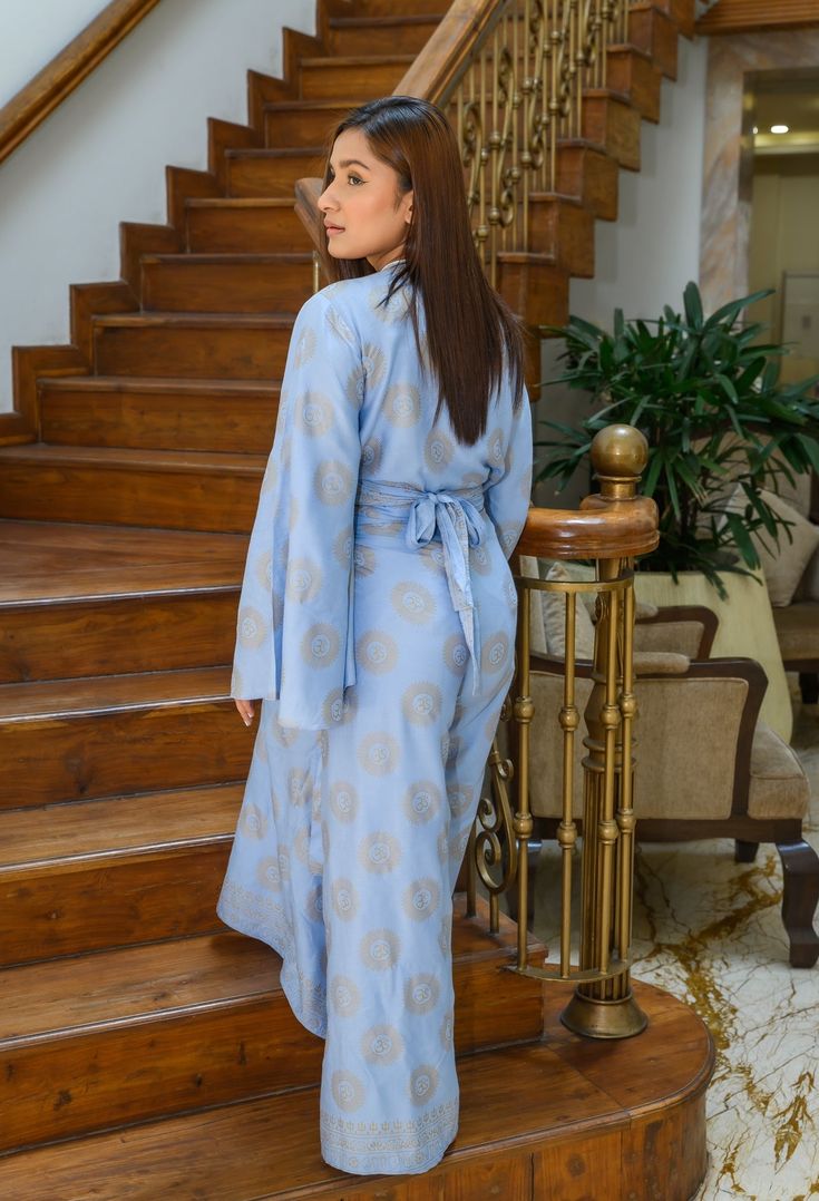 Step into serene style with the Ohm-around Wrap Set- a chic and comfortable ensemble that brings tranquility and elegance to your everyday wardrobe. This set includes wide-legged wrap pants, designed with an adjustable wrap-around tie for a customizable fit. The flowy silhouette of the pants ensures maximum comfort, while the captivating Ohm print infuses a sense of zen into your look. Complementing the pants is an open tie top, distinguished by its graceful butterfly sleeves. The open tie front Elegant Spring Palazzo Set Maxi Length, Chic Long Sleeve Palazzo Set For Summer, Spring Wrap Skirt, Elegant Maxi-length Palazzo Set For Summer, Chic Tie Waist Loungewear Sets, Chic Loungewear Sets With Tie Waist, Elegant Spring Matching Palazzo Set, Elegant Spring Palazzo Matching Set, Elegant Loungewear Kimono Maxi Length