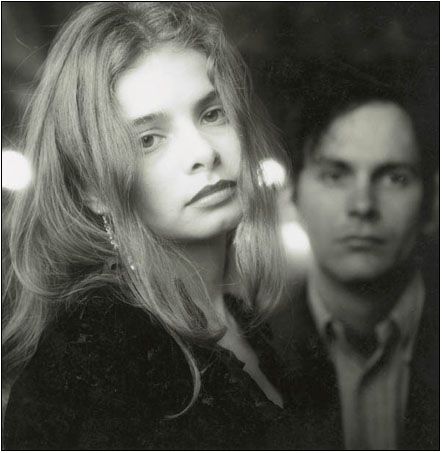 black and white photograph of man and woman looking at each other with serious look on their faces