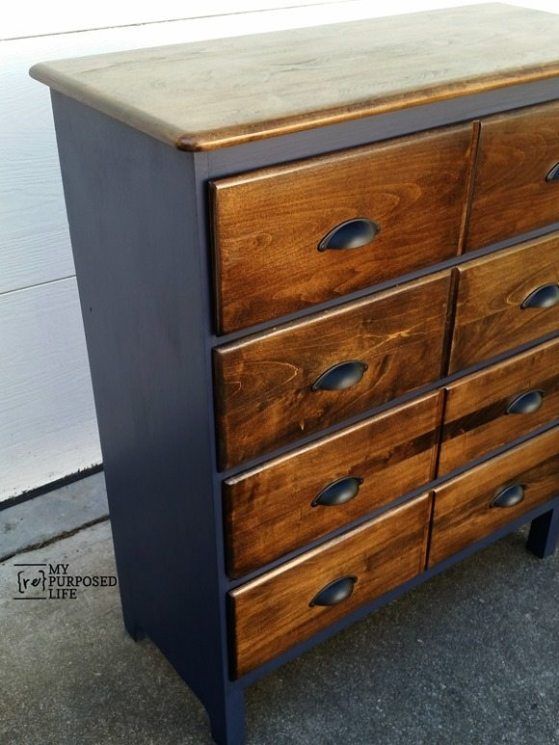 an old wooden dresser is painted black and brown