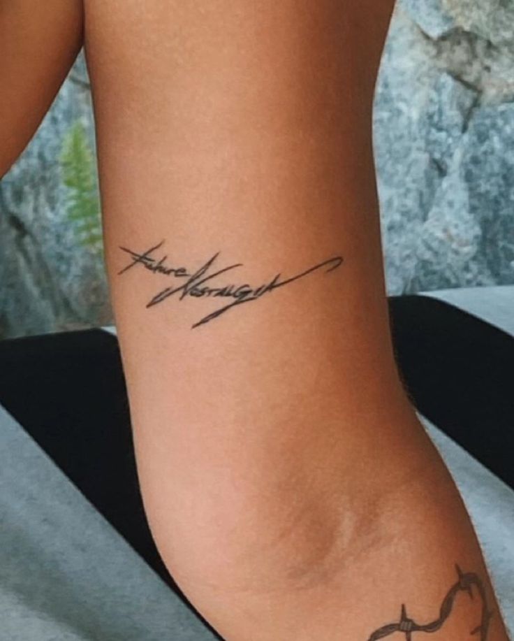 a woman's arm with a tattoo on it that reads, love and strength