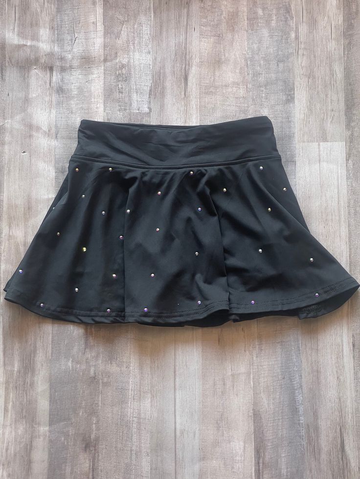 The cutest skirt to match all of your rhinestone tops! Skirt is a lightweight material with built in shorts, so it's perfect for practice! Stones are AB crystal and go all the way around so you get shimmer and sparkle all over! This skirt will definitely help you create the PERFECT practice set! Buy a bra with different color stones?? Reach out so we can get them to match! Washing instructions: Turn skirt inside out and hand wash in cold water. Lay flat or hang to dry. Dry cleaning and machine w Cheerleading Mini Skirt Bottoms With Built-in Shorts, Cheerleading Mini Skirt With Built-in Shorts, Cheerleading Skirt With Built-in Shorts, Fitted Mini Skirt With Built-in Shorts For Cheerleading, Cheerleading Stretch Mini Bottoms, Mini Skirt Bottoms With Built-in Shorts For Cheerleading, Party Mini Skirt With Elastic Waistband, Spring Stretch Embellished Skirt, Spring Embellished Stretch Skirt