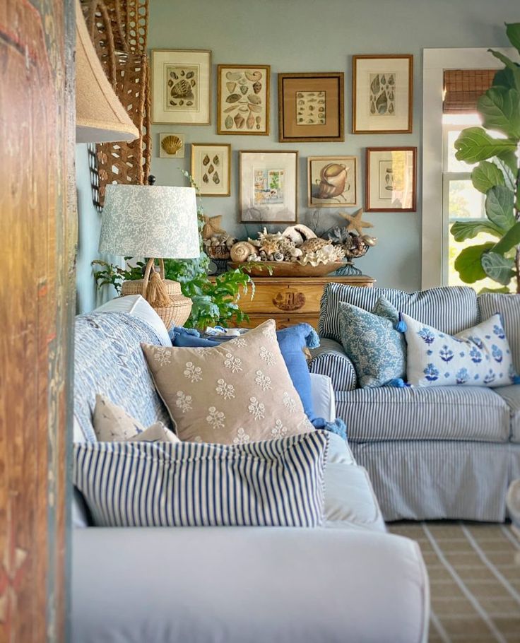 a living room filled with blue couches and pillows on top of it's covers