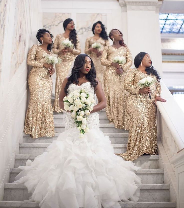 a bride and her bridal party on the stairs