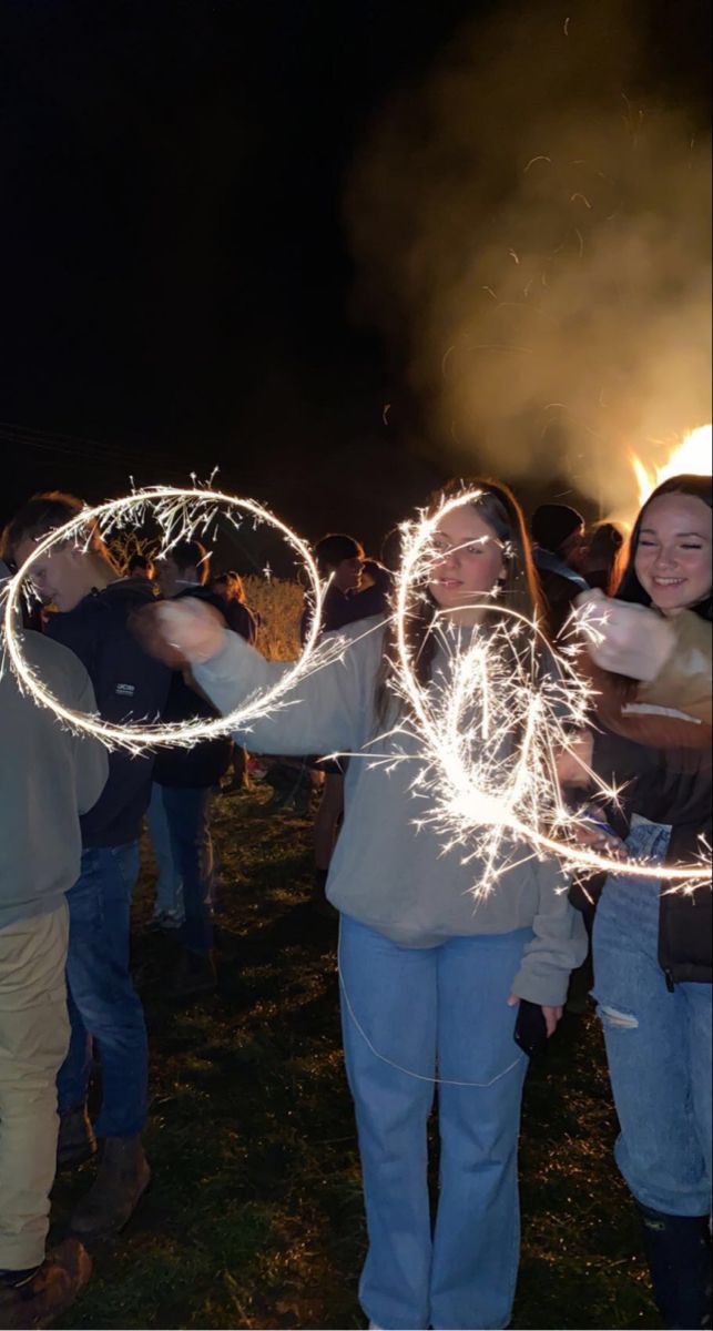 a group of people holding sparklers in their hands with the word love written on them