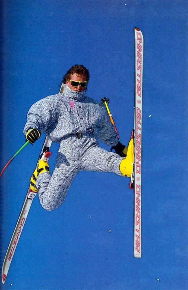 a man flying through the air while riding skis