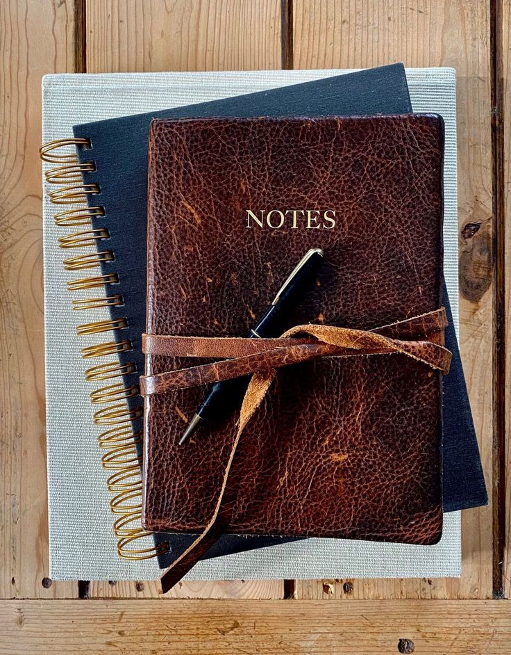 two notebooks tied together on top of each other with the words notes written on them