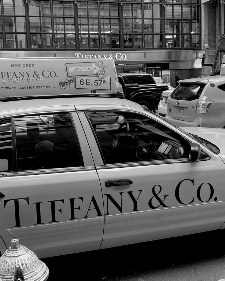 a black and white photo of a taxi cab