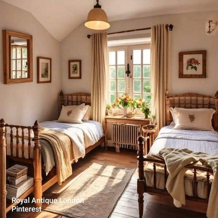 two twin beds in a bedroom with wooden floors and white walls, along with an area rug on the floor