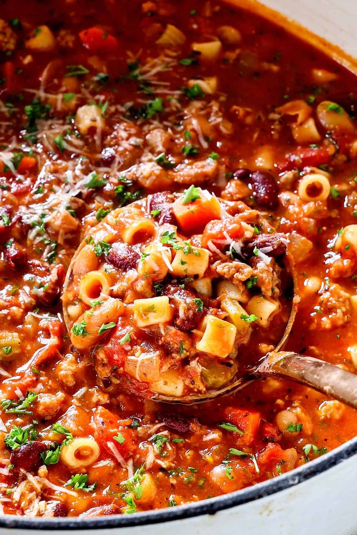 a ladle full of pasta and meat soup