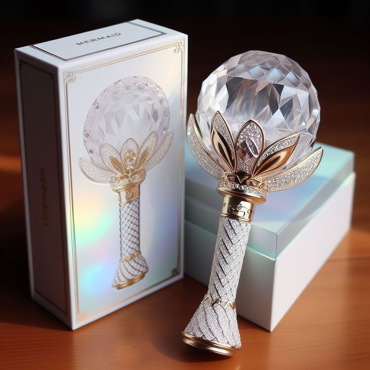 a crystal ball on top of a table next to a box and an object in the shape of a flower