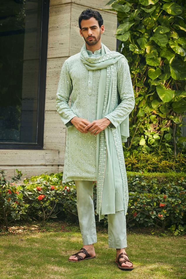 Pastel green kurta with floral chikankari embroidery and mirror work highlights. Comes with matching dupatta and pant.
Components: 3
Pattern: Embroidered
Type Of Work: Chikankari, Mirror
Neckline: Mandarin
Sleeve Type: Straight Full
Fabric: Kurta and Dupatta- Georgette, Pant- Cotton Satin
Color: Green
Other Details: 
Model height: 6ft, wearing size M
Occasion: Sangeet - Aza Fashions Pastel Green Kurta Men, Kurta With Dupatta Men, Mehendi Outfits For Men, Green Chikankari Kurta, Bengali Groom, Lakhnavi Kurta, Brothers Outfits, Wedding Guest Outfit Inspiration, Sangeet Ceremony