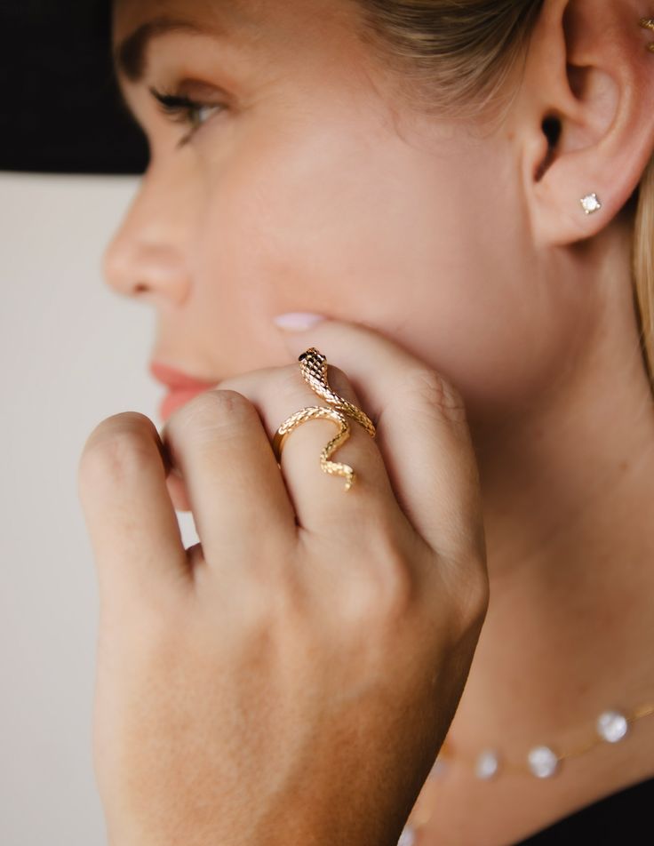 Intertwine yourself in luxury with our Snake Ring. The delicate snake design is expertly crafted with 14k gold plating and rhodium plating, exuding elegance and craftsmanship. Make a statement with this unique and timeless piece that alludes to the exotic and alluring world of the snake. Made in Colombia Formal Snake-shaped Jewelry, Elegant Open Snake Ring For Gift, Adjustable Yellow Gold Elegant Snake Ring, Adjustable Elegant Snake Ring In Yellow Gold, Elegant Adjustable Yellow Gold Snake Ring, Snake-shaped Jewelry Gift, Elegant Gold Plated Snake Jewelry, Formal Gold Snake Ring, Elegant Gold Plated Snake-shaped Jewelry