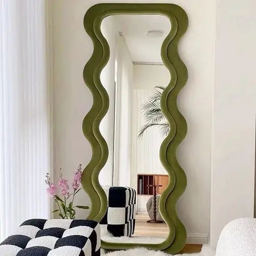 a mirror that is sitting in the middle of a room with a black and white checkerboard floor