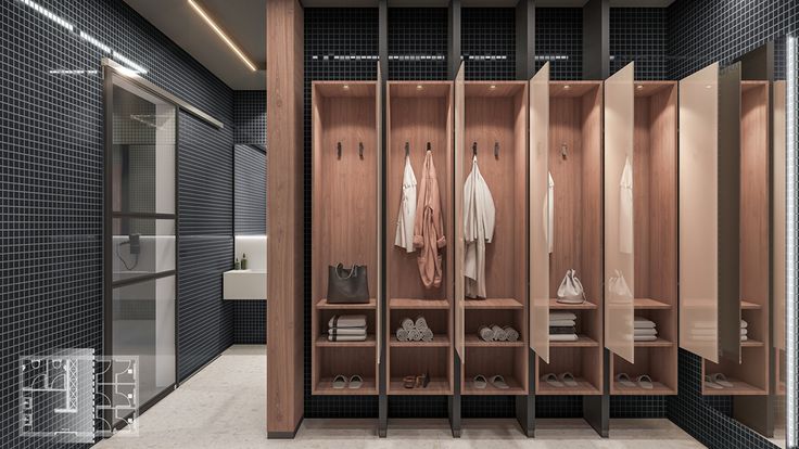 an empty walk in closet with wooden shelves and clothes hanging on the wall, next to a mirror