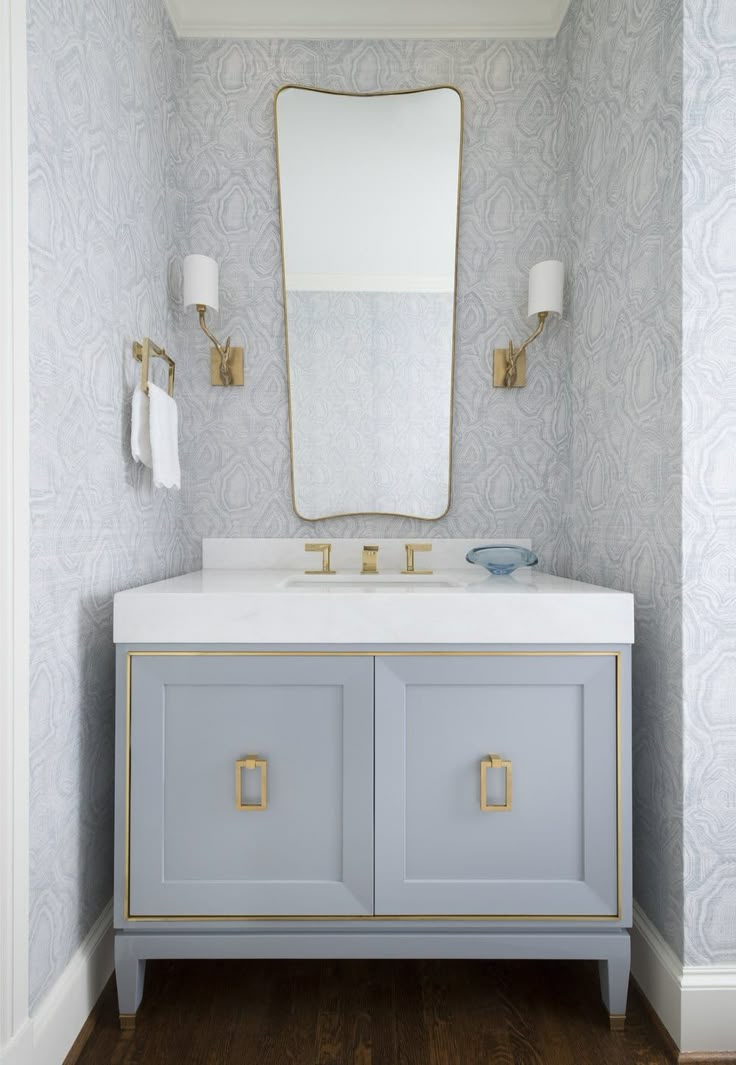 a bathroom vanity with a large mirror above it