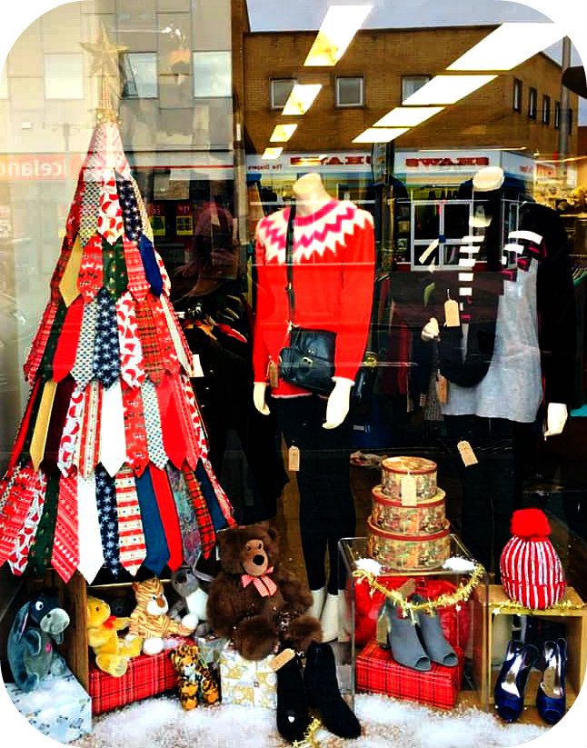 there is a display in the window of a clothing store with many items on it