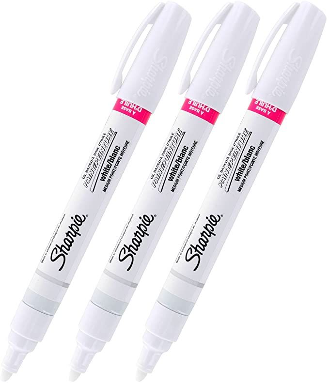 three white marker pens sitting next to each other