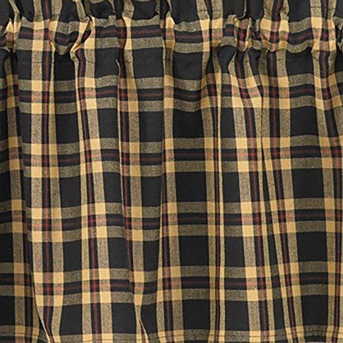 a black and tan checkered curtain hanging on a rod