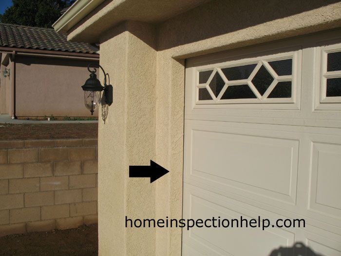 a white garage door with an arrow pointing to the right