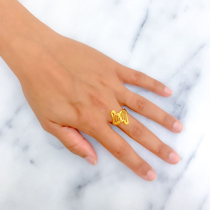 This ring stands out with its bold, ethereal design, crafted from 22k yellow gold and weighing 3.1 grams. Available in size 8 with options for resizing, it's perfect for those who desire a standout piece that combines majestic allure with a lightweight feel. Ideal for adding a touch of drama and elegance to any look, this ring is a statement piece that beautifully marries modern design with timeless gold luxury. Product Details Gold Purity(karat): 22k Gold Weight(grams): 3.1 Item Finish: Yellow Gold Ring Size: ﻿8﻿ Ring Sizing Available: Yes // Gold Hallmarked Butterfly Ring For Wedding, Gold Butterfly Ring Hallmarked For Wedding, 22k Gold Yellow Ring As A Gift, 22k Gold Yellow Ring Gift, 22k Gold Hallmarked Promise Ring, 22k Gold Open Ring, Yellow Gold Rings Gift, 22k Gold Open Ring For Anniversary, Gift 22k Gold Yellow Ring