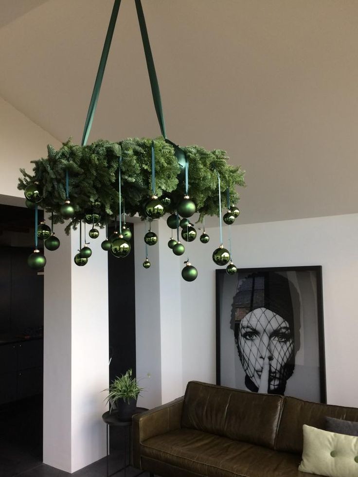 a living room with a couch and christmas decorations hanging from the ceiling over it's head