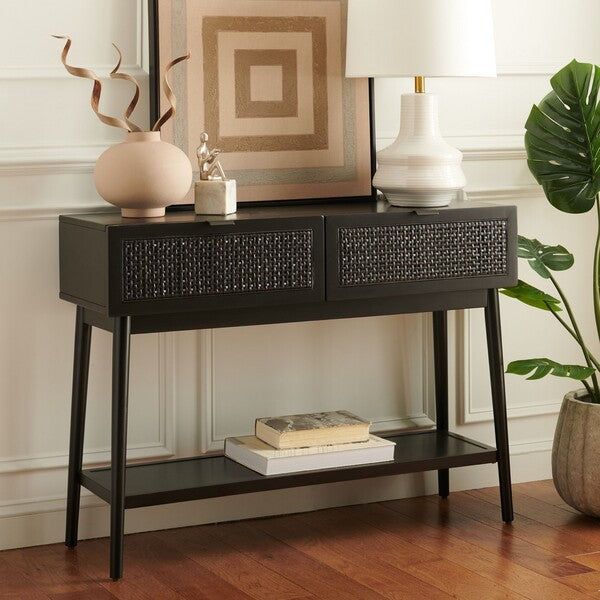 a black console table with two vases and a lamp