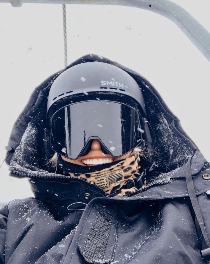 a person wearing a helmet and goggles in the snow