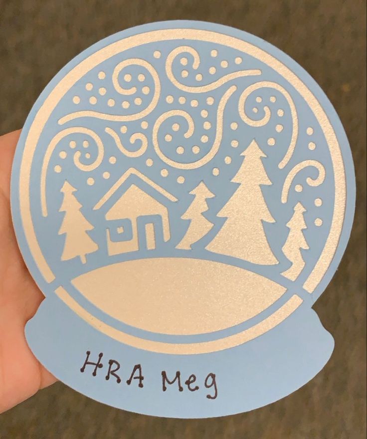 someone is holding up a sticker with a snow globe in the center that says, hra me