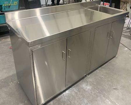 a large stainless steel counter in a garage