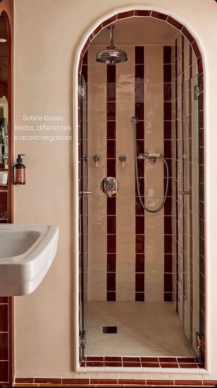 a bathroom with a sink, mirror and shower stall in the corner next to it