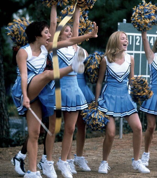 the cheerleaders are all dressed in blue and white