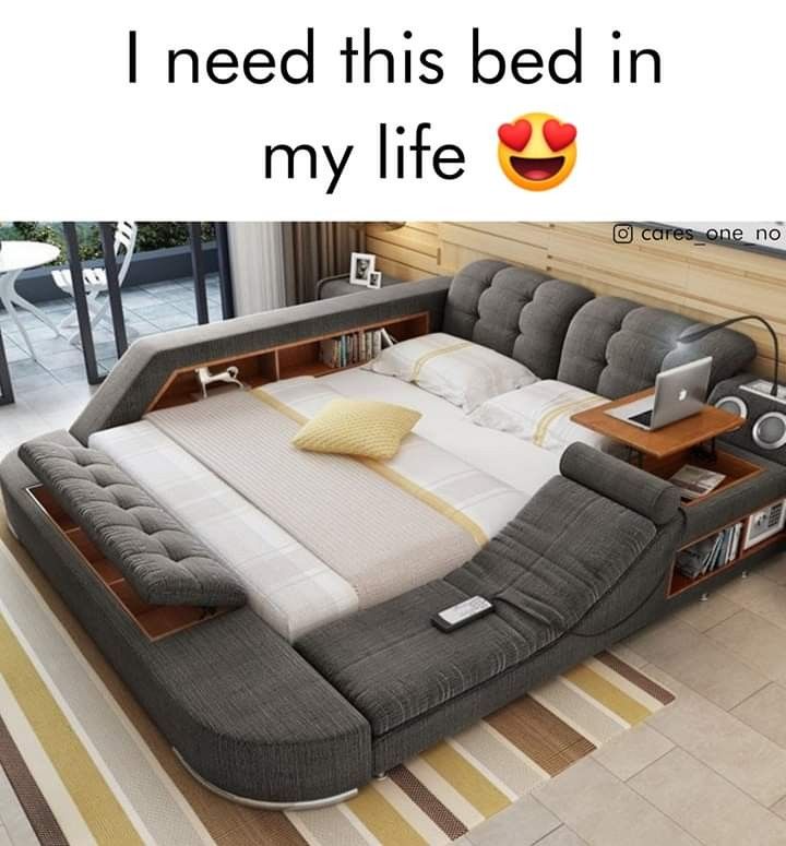 a bed that is in the middle of a room with a laptop on top of it