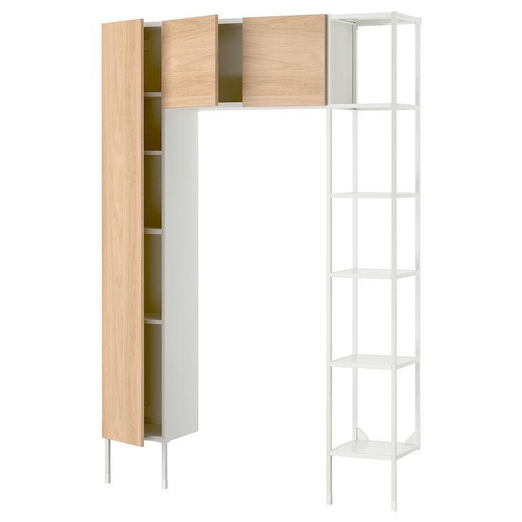 an open bookcase with shelves and drawers in white and light wood finish, against a white background