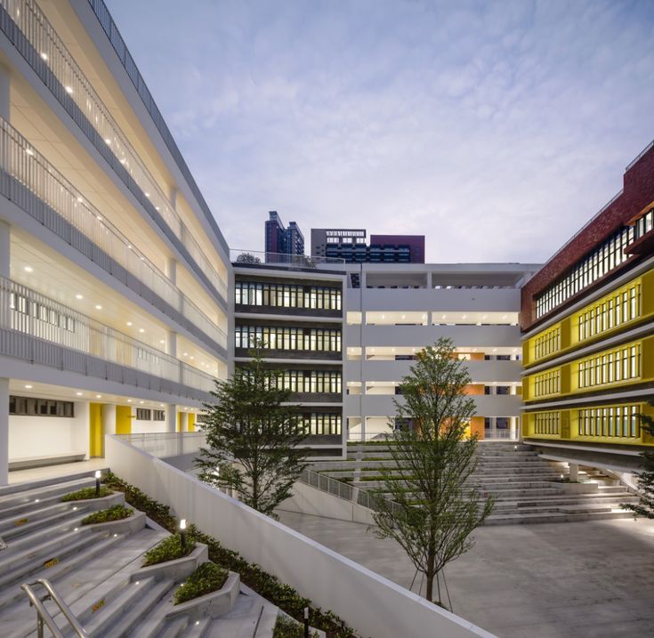 an empty courtyard with stairs leading up to the building