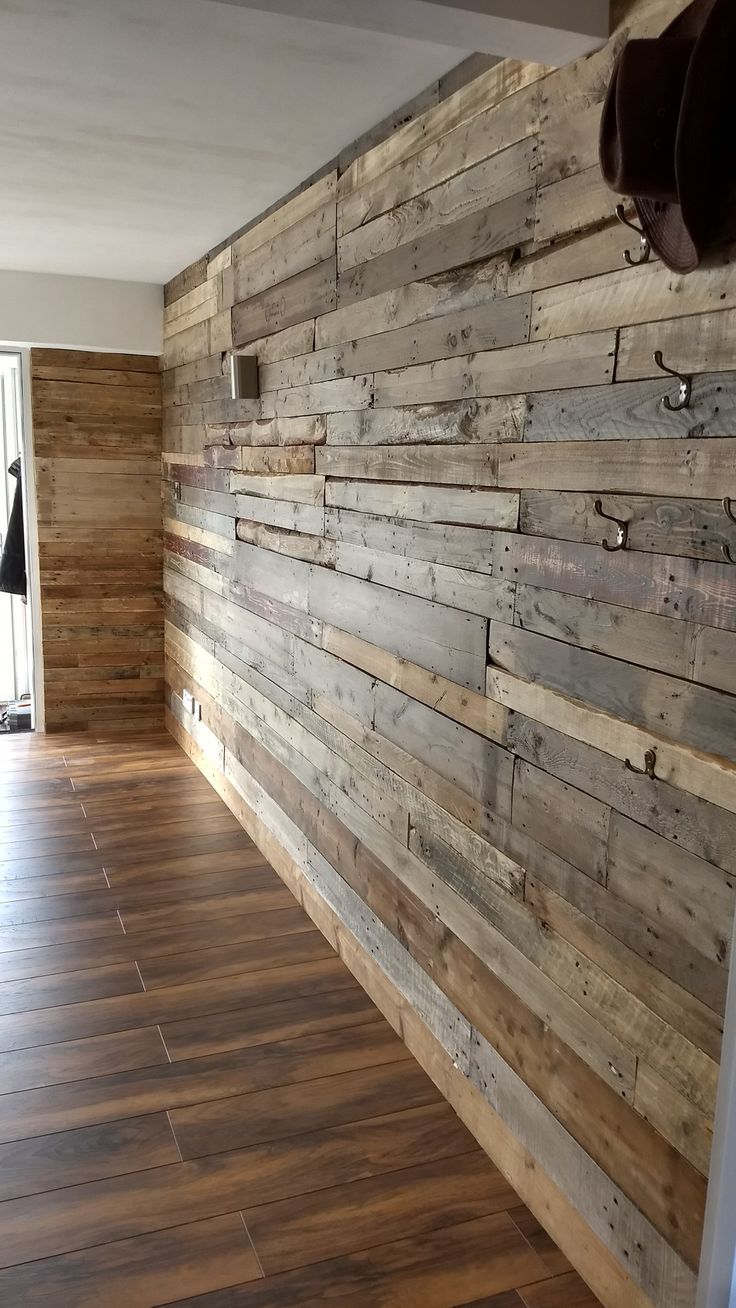 an empty room with wood planks on the wall