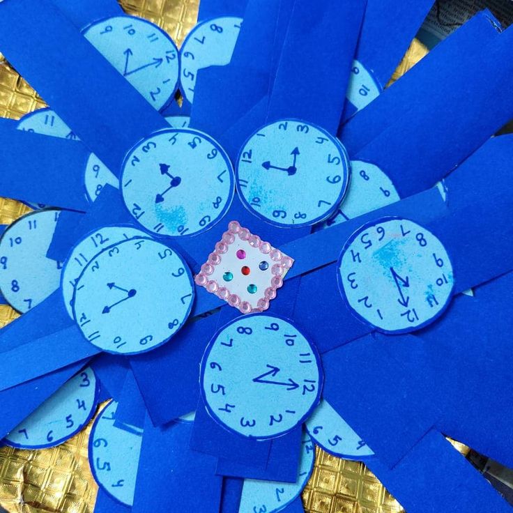 a blue clock made out of pieces of paper