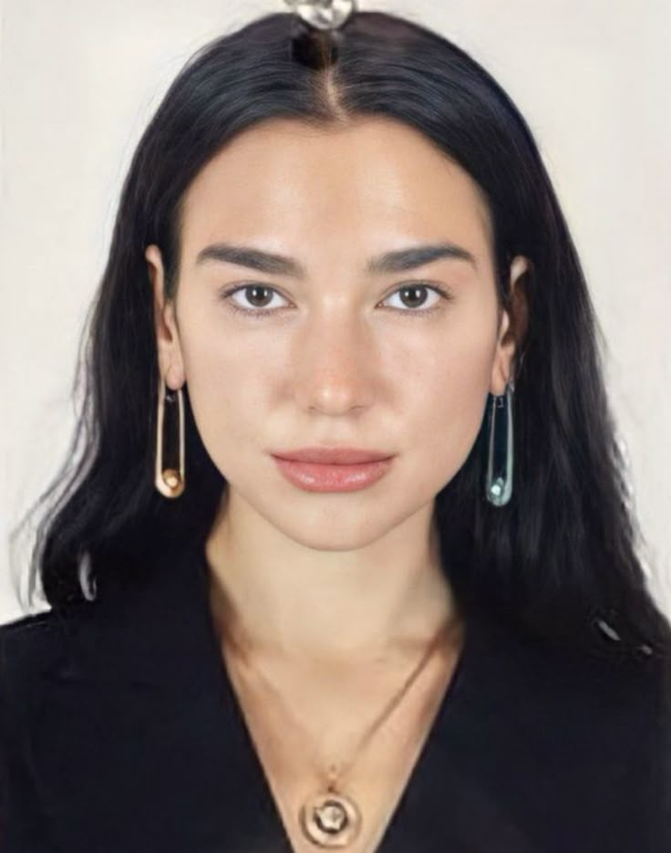 a woman with long black hair and earrings on her head, looking at the camera