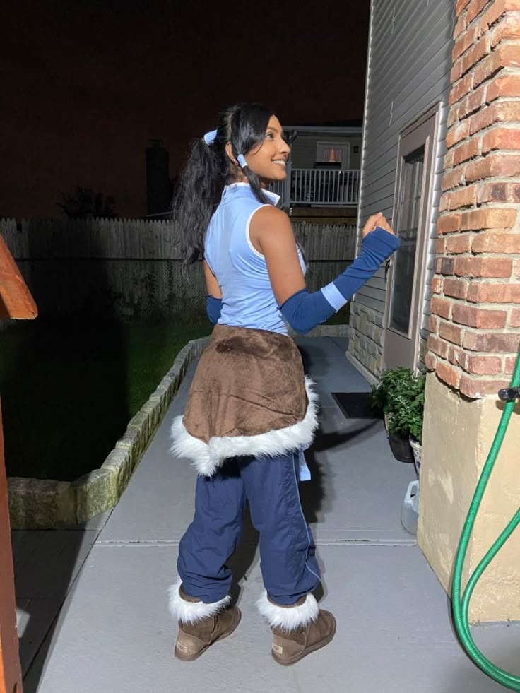 a woman in costume is standing on the porch