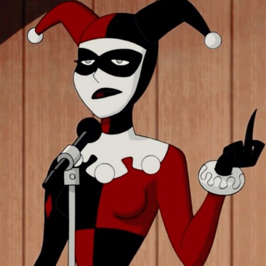 a woman in a red and black costume holding a microphone