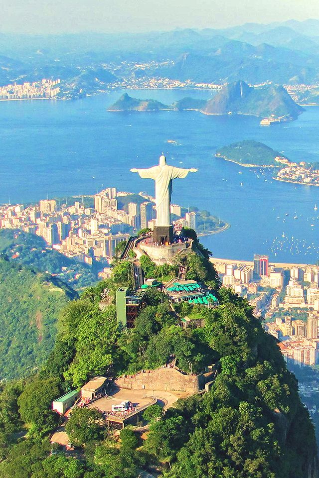 an aerial view of the statue of christ on top of a hill in rio, brazil