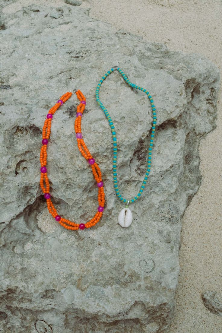 Elevate your beach ensemble with the Elsa Shell Necklace (named after our favourite Ibu). Made from recycled polyester beads, it's a sustainable and stylish choice. Rock it solo or layer it with our Balik Double Beaded Necklace for a vibrant summer vibe.