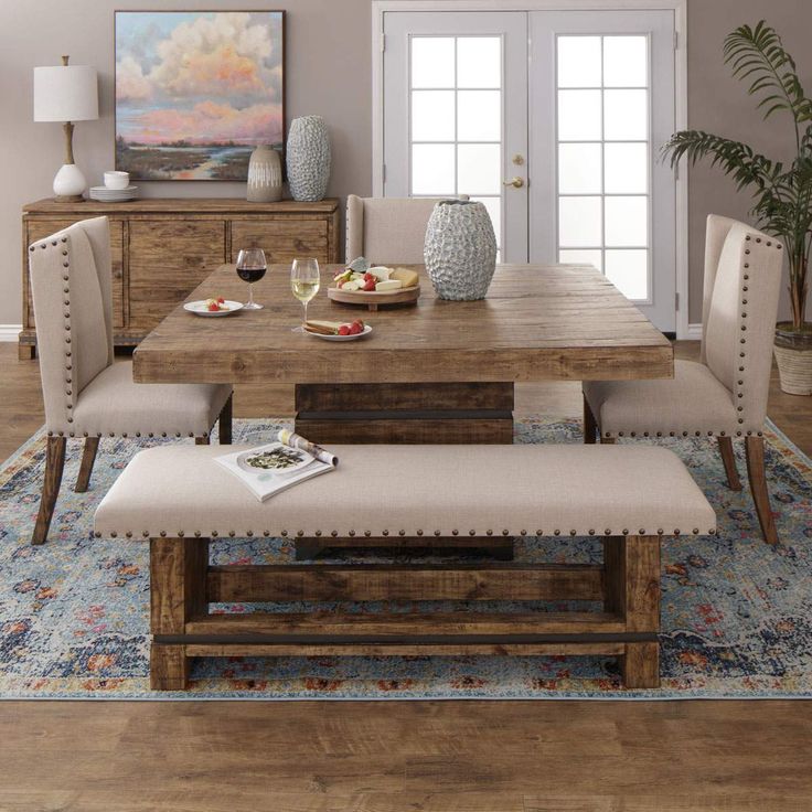 a dining room table with bench and chairs