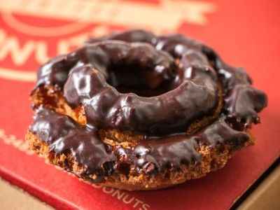 a chocolate covered doughnut sitting on top of a box