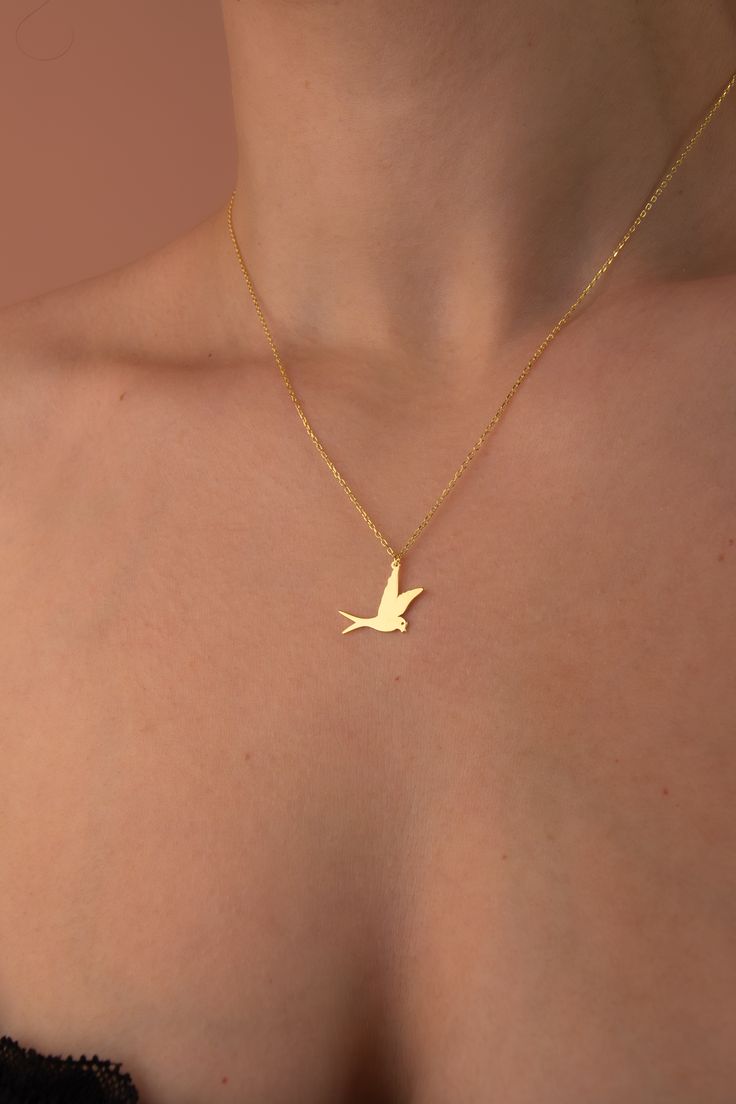 Elegant gold pendant showcasing a flying dove, symbolizing peace and serenity. Bird Design Pendant Necklace As A Gift, Bird Design Pendant Necklace As Gift, Gold Pendant Necklace With Bird Design, Bird Design Pendant Necklace For Gift, Bird Design Pendant Necklace Gift, Bird Pendant Necklace For Gift, Gold Bird-shaped Jewelry With Bird Design, Gold Necklace With Bird Design As Gift, Gold Necklace With Bird Design For Gift