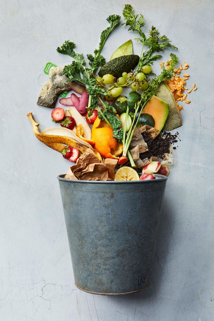 a trash can filled with vegetables and fruits