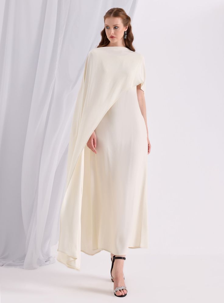 WF ATELIER Off White Two-piece Dress and Cape, you can style separately with different outfıt Model height: 177 CM 100% Viscose Length: 137 cm Cape Long sıde :145 cm Pre-draped Cape Evening Dress, Elegant Cream Dresses With Draped Sleeves, White Cape Sleeve Dress For Evening, Formal Pre-draped Cape Dress, Cream Pre-draped Evening Dress, White Cape Sleeve Evening Dress, Silk Cape Dress For Parties, Evening Dress With Cape Shape And Pre-draped Style, Cream A-line Silk Dress