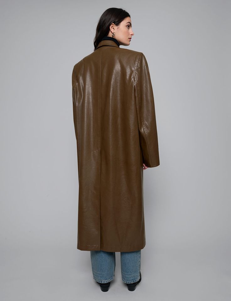 Brown leather trench coat with dropped oversized lapel and front pockets .100% faux leather100% polyester liningFit is oversizedFront pockets Padded shoulders Single button closureModel is wearing one size and model's height is 5.8"/172 cmImported Sleek Brown Leather Outerwear, Leather Outerwear With Double Button Closure For Fall, Sleek Leather Outerwear With Hidden Button Closure, Oversized Brown Leather Outerwear, Oversized Leather Winter Outerwear, Classic Soft Leather Outerwear For Fall, Long Leather Jacket With Pockets For Work, Single Breasted Leather Long Coat, Single Breasted Long Leather Coat