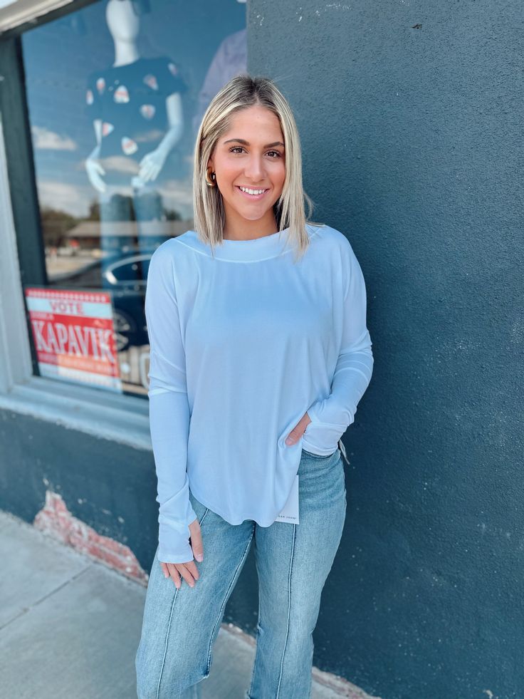 Stay cozy and chic in our River Open back Knit Top. This ribbed, oversized top features a boat neck and long sleeves with thumb holes for added style and comfort. The high low curved hemline adds a playful touch. Available in White or Sage Green, made from a soft blend of 60% Polyester, 35% Rayon, and 5% Spandex. Everyday Long Sleeve Stretch Sweater, Versatile White Long Sleeve Knit Top, White Long Sleeve Versatile Knit Top, Layering Long Sleeve Top With Thumbholes, Everyday Long Sleeve Knit Top, Long Sleeve Soft Knit Stretch Top, Long Sleeve Soft Knit Tops For Layering, Soft Knit Long Sleeve Tops For Layering, Oversized Long Sleeve Knit Top For Layering