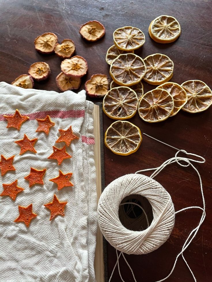 oranges and twine are on the table next to an old book with string