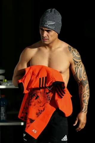 a shirtless man holding an orange towel